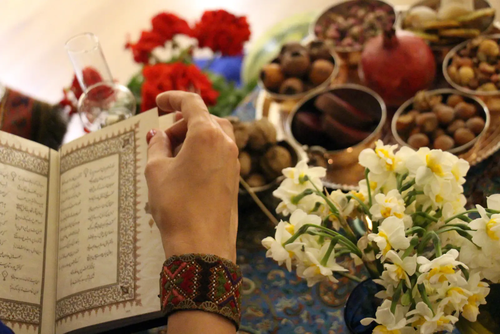 A Miniature community member holding a book of Hafez
