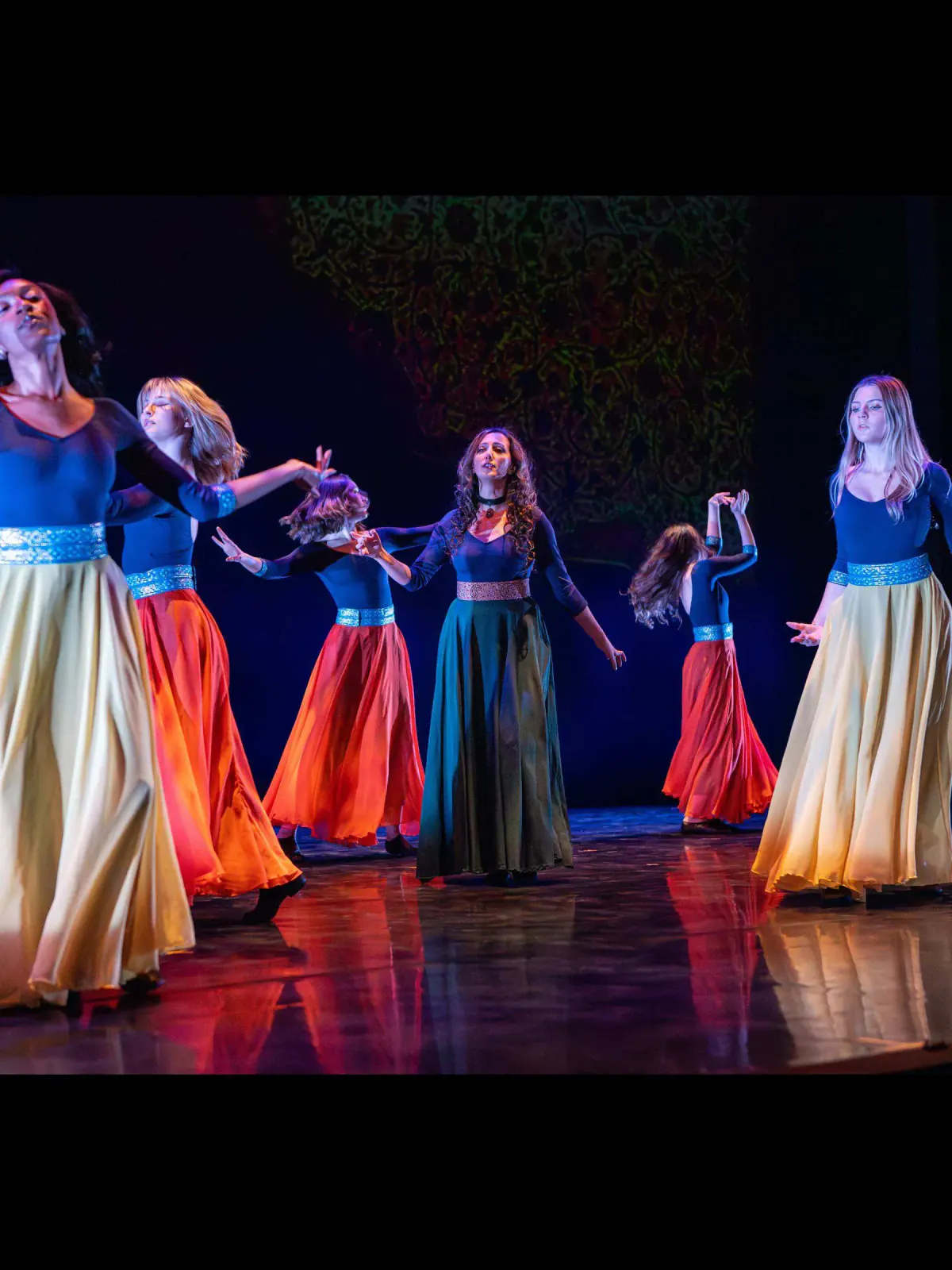The Khazan ensemble extending their arms in a shared gesture